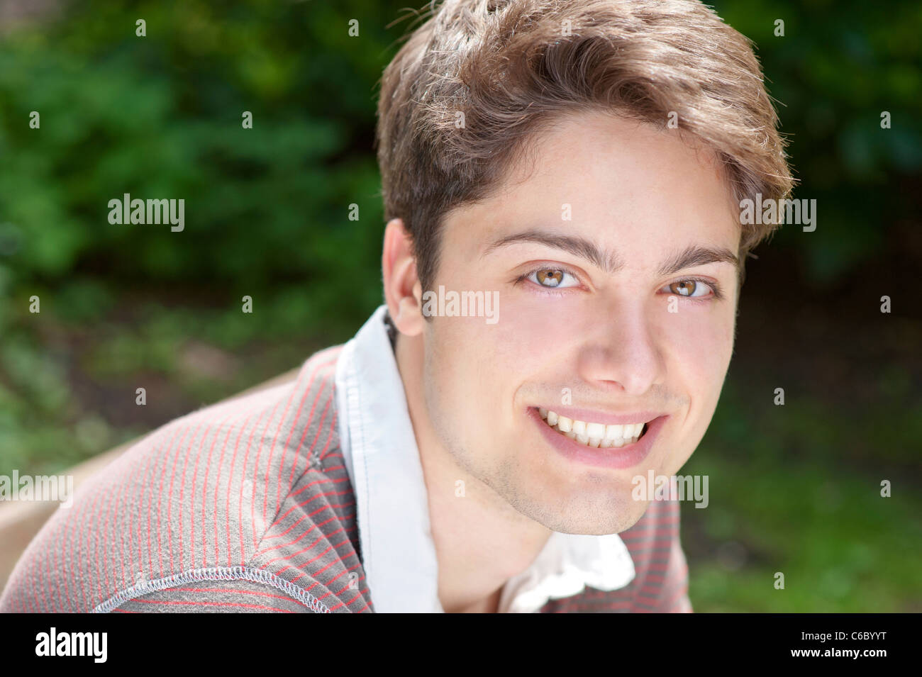Young and smiling man in the park Stock Photo - Alamy