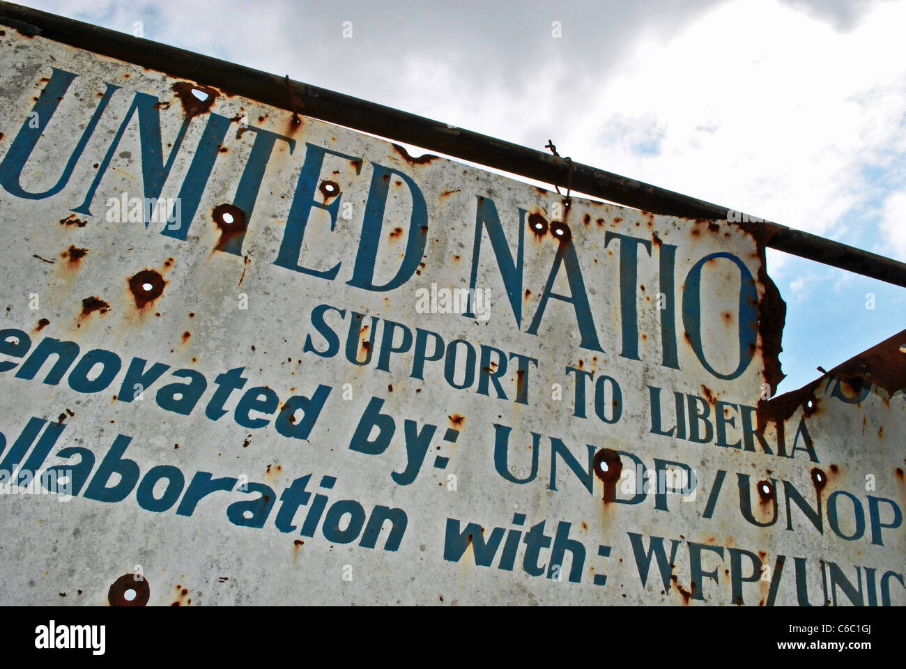 UN sign riddled with bullets in Zorzor, Liberia Stock Photo