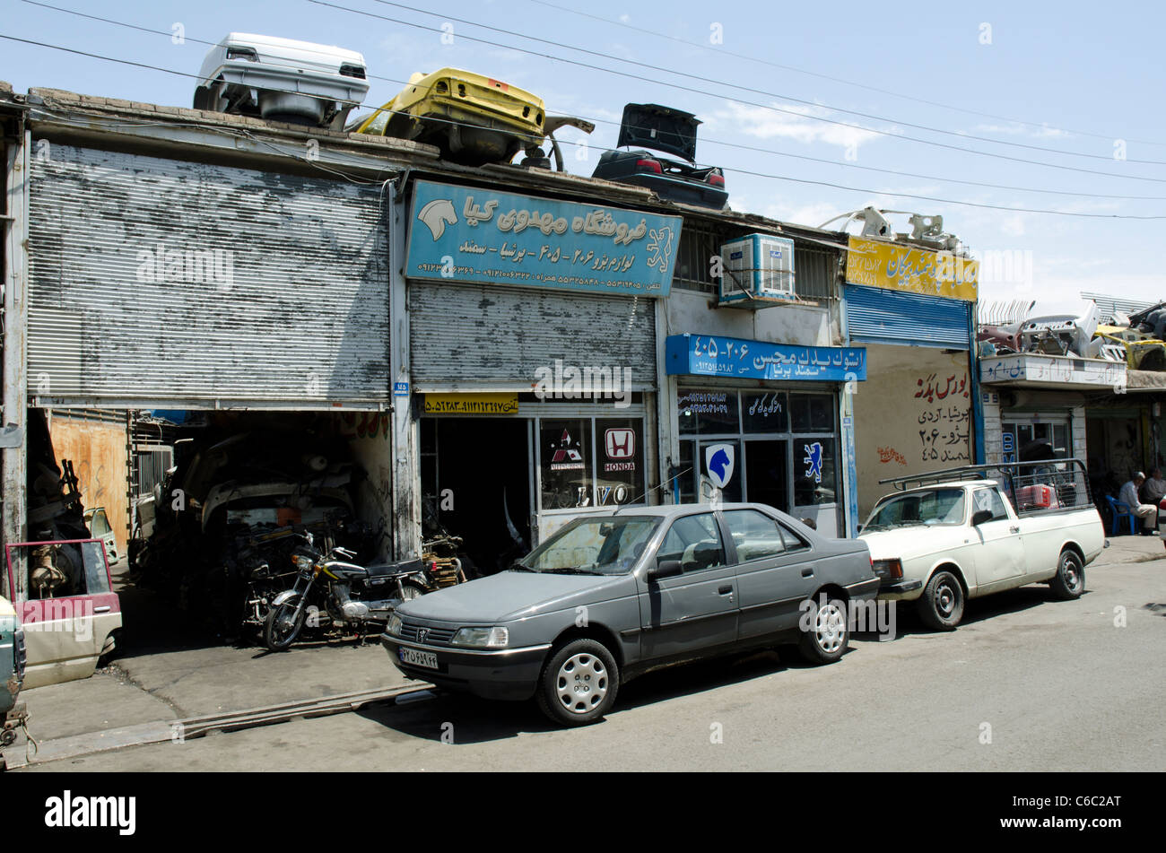 Scrap vehicle bodies stored above the shops in, downtown Tehran. Stock Photo
