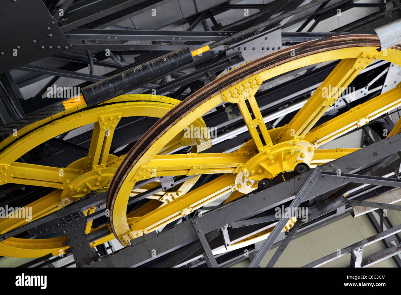 Part of mechanism with large yellow wheels Stock Photo