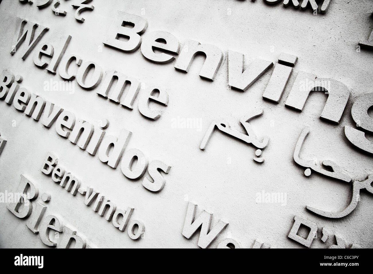 Board with greetings in different languages close up Stock Photo
