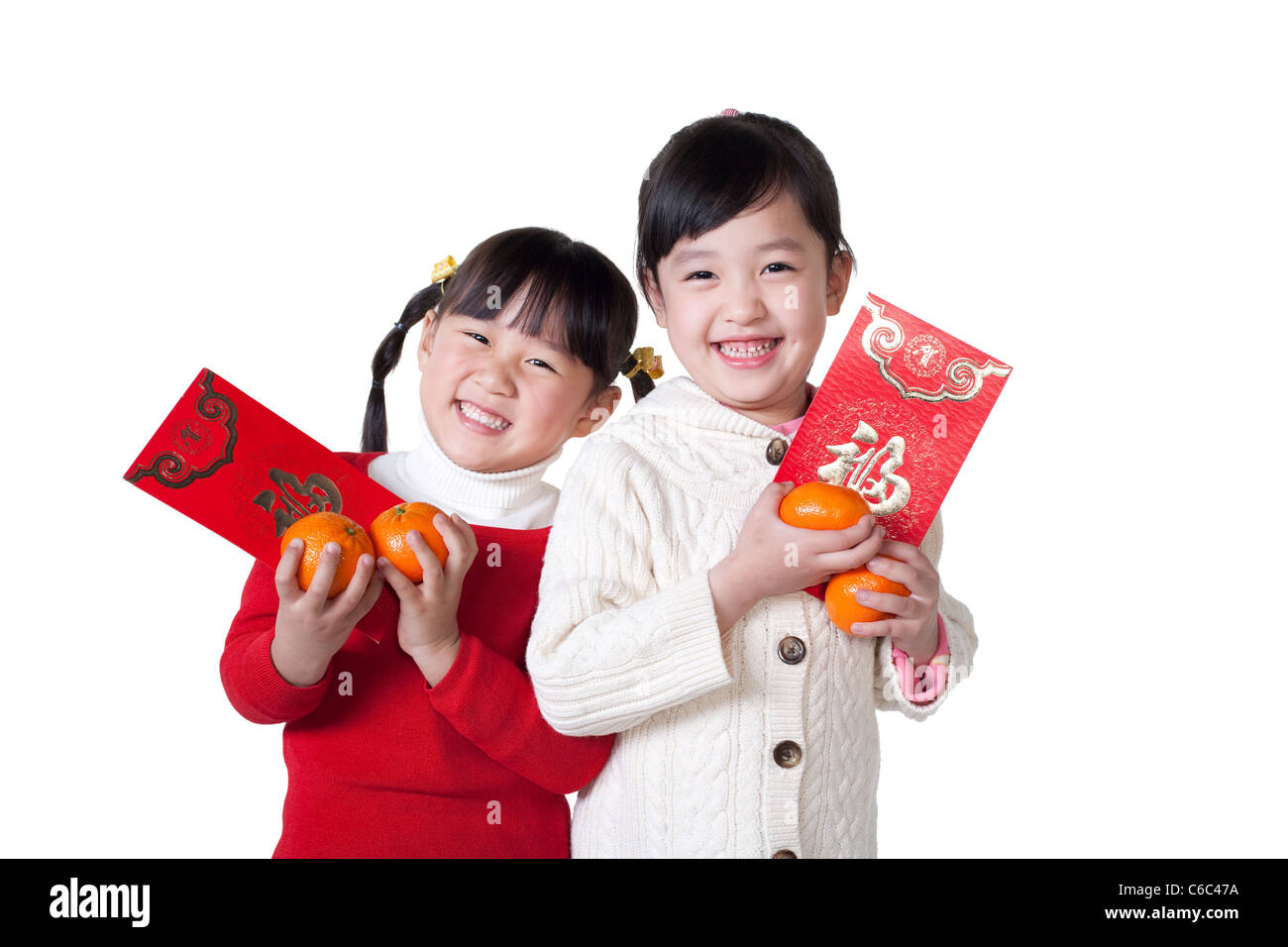 Two Chinese girls holding red envelopes Stock Photo