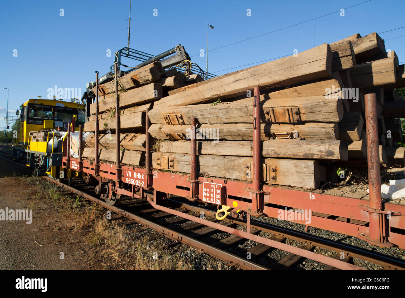 Trainload of old , wooden , decommissioned and creosote treated railroad sleepers , Finland Stock Photo