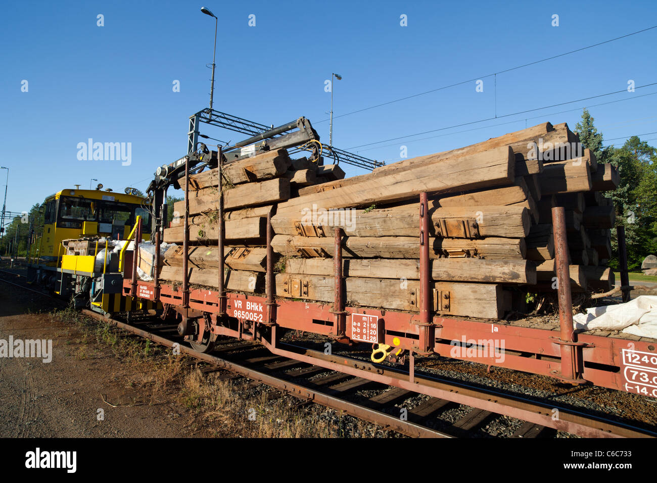 Train load of wooden decommissioned old railroad sleepers , Finland Stock Photo