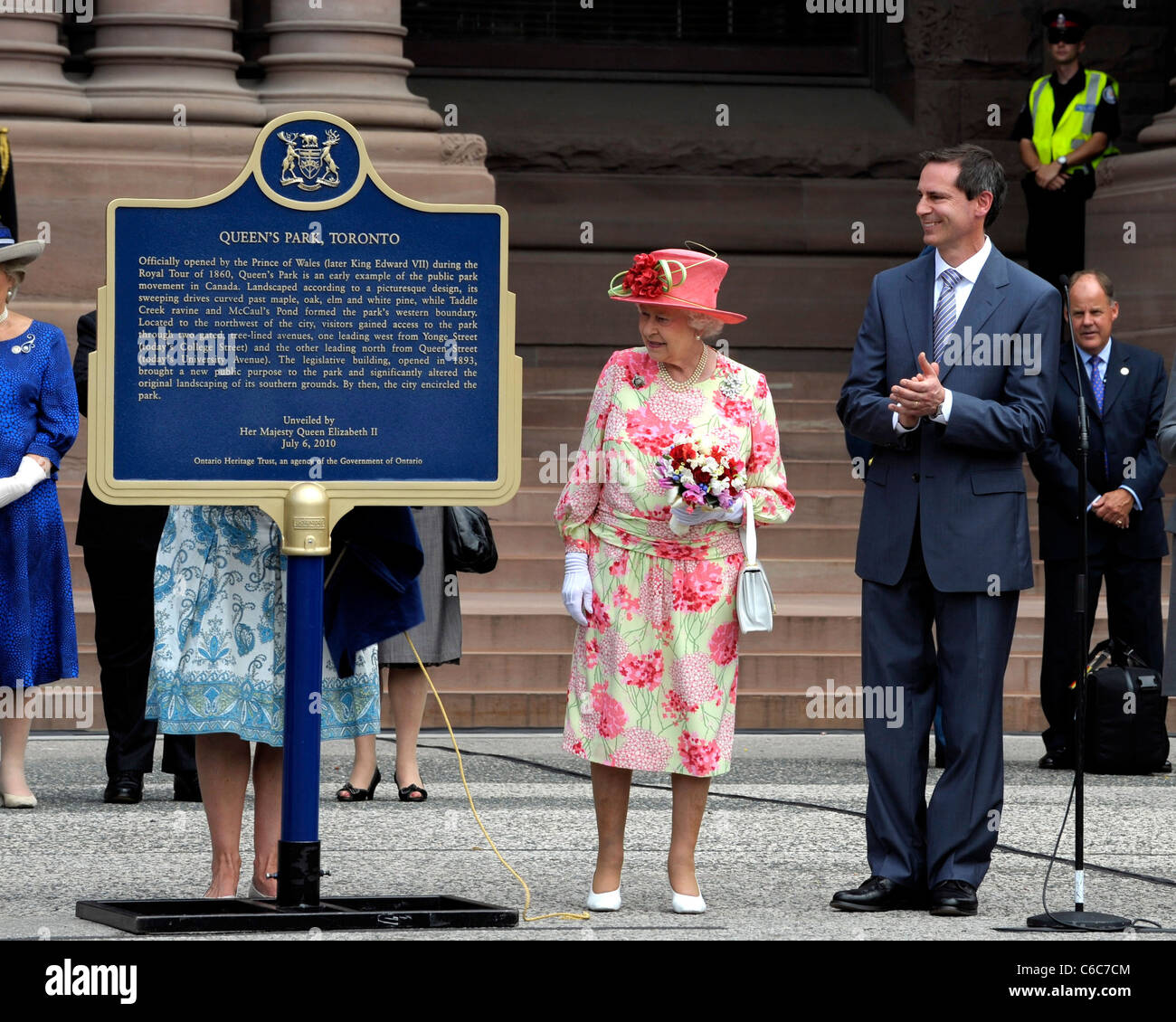 Queen Elizabeth II and Ontario Premier Dalton McGuinty Queen Elizabeth II unveiling a commemorative plaque marking 150 years of Stock Photo