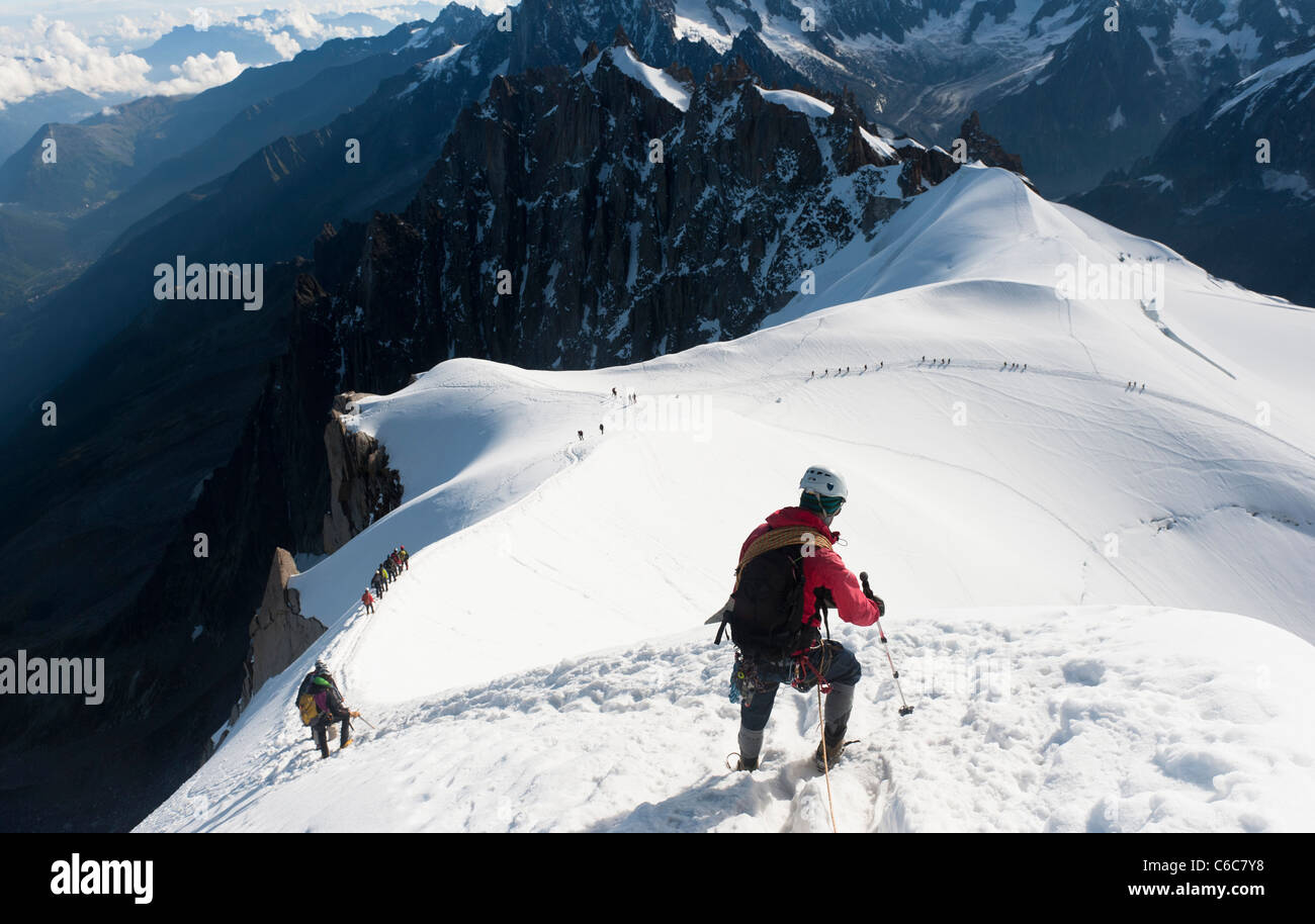 Climbers walking down the airy ridge of Aiguille du Midi at Chamonix, France Stock Photo