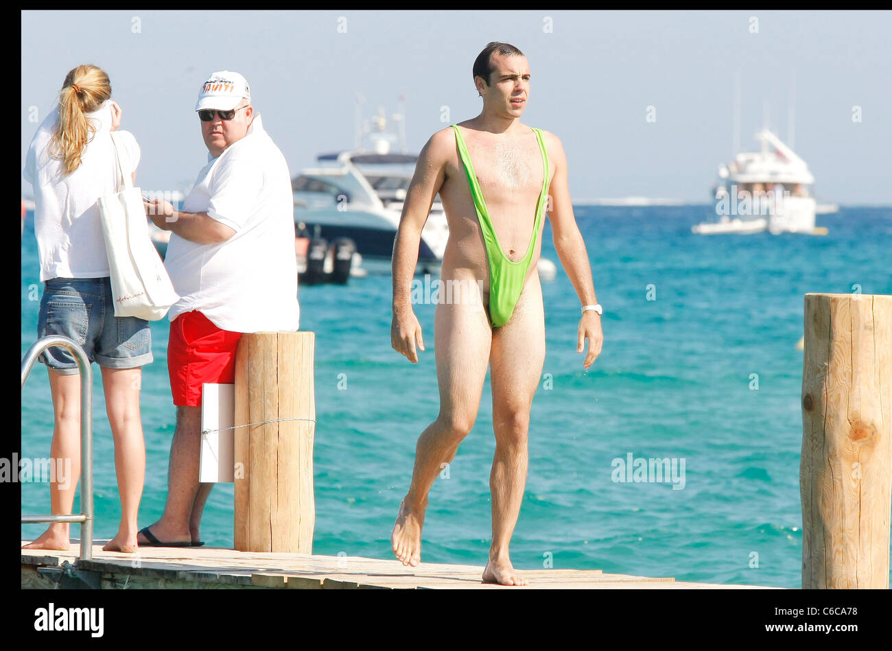 A Swiss tourist wears a funny bathing suit and amuses other tourists near  Club 55 in Pampelona Beach. St. Tropez, France Stock Photo - Alamy