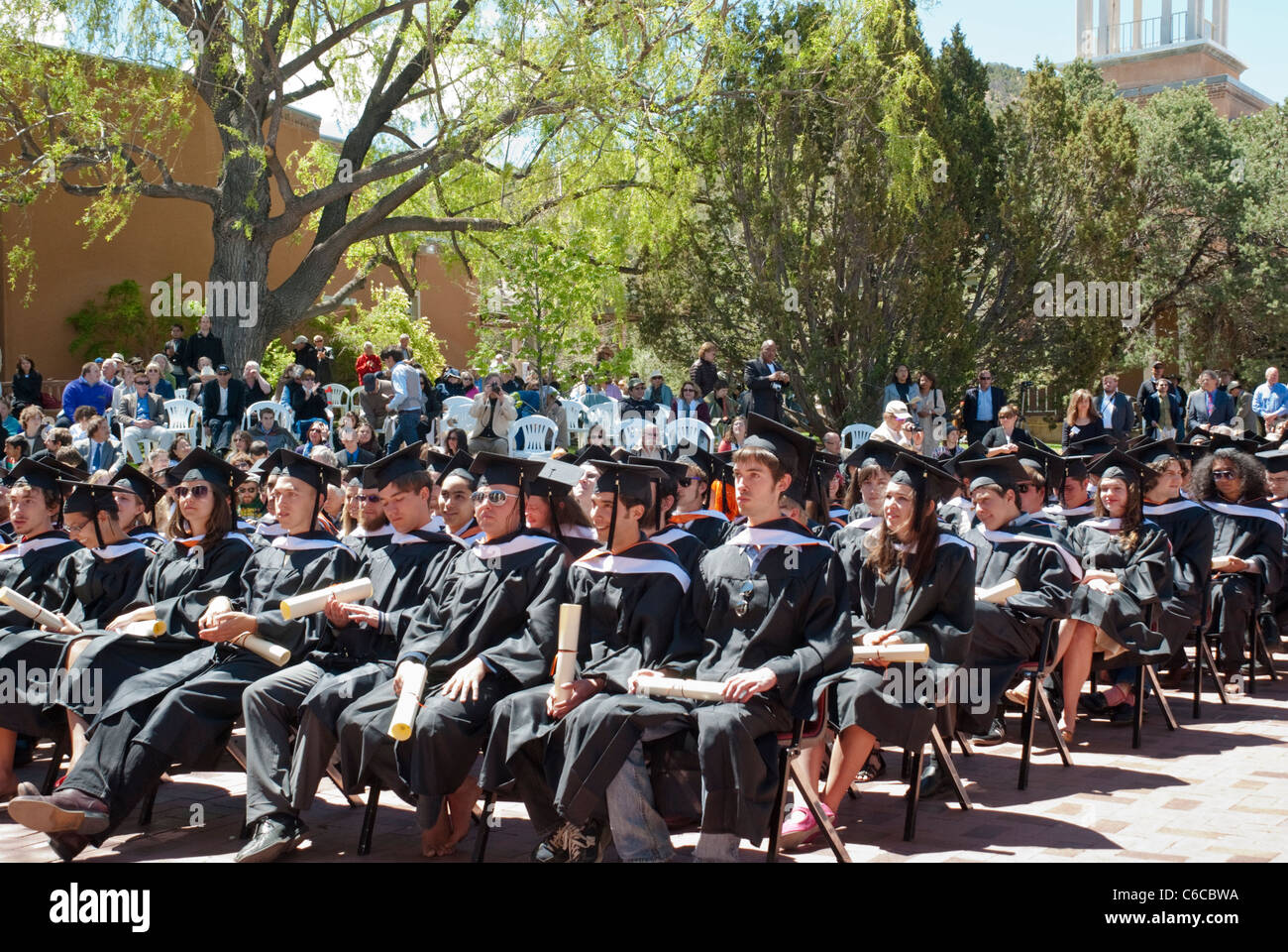 Many of the graduation seniors pay attention to the speeches on graduation day at St. Johns College in Santa Fe, New Mexico. Stock Photo
