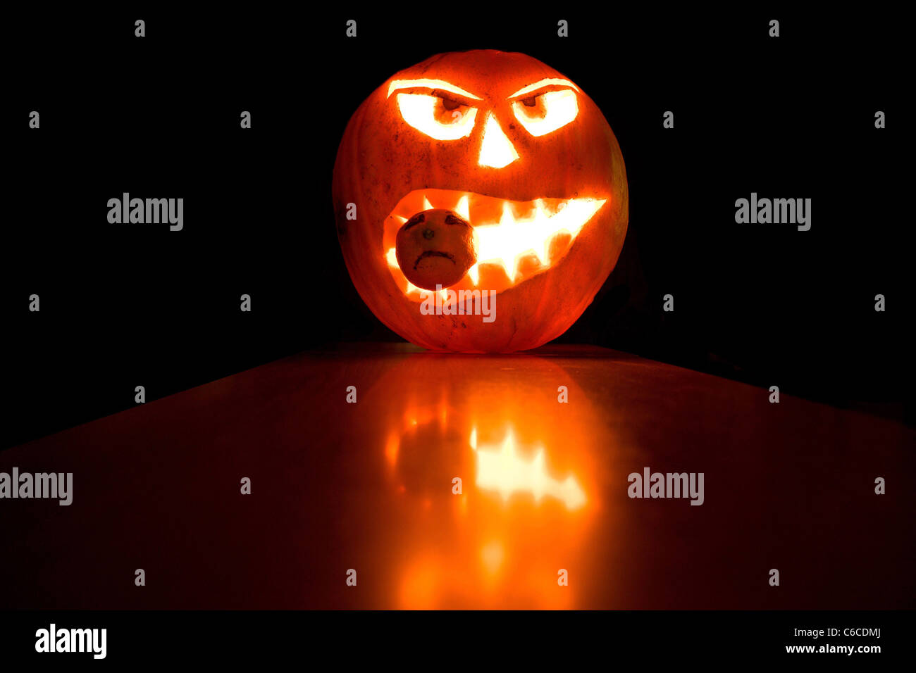 Halloween pumpkin light in the dark background, with reflections Stock Photo
