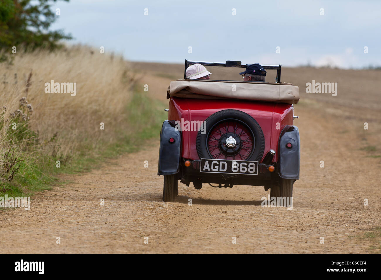 Vintage Austin 7 convertible traveling along a dusty toad Stock Photo