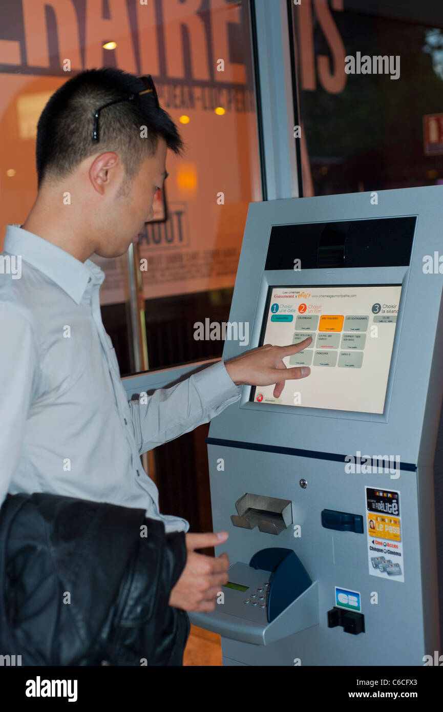 Paris, France, Chinese Man Buying FIlm Ticket from Vending Machine at  French Cinema Theatre on Champs Elysees Stock Photo - Alamy