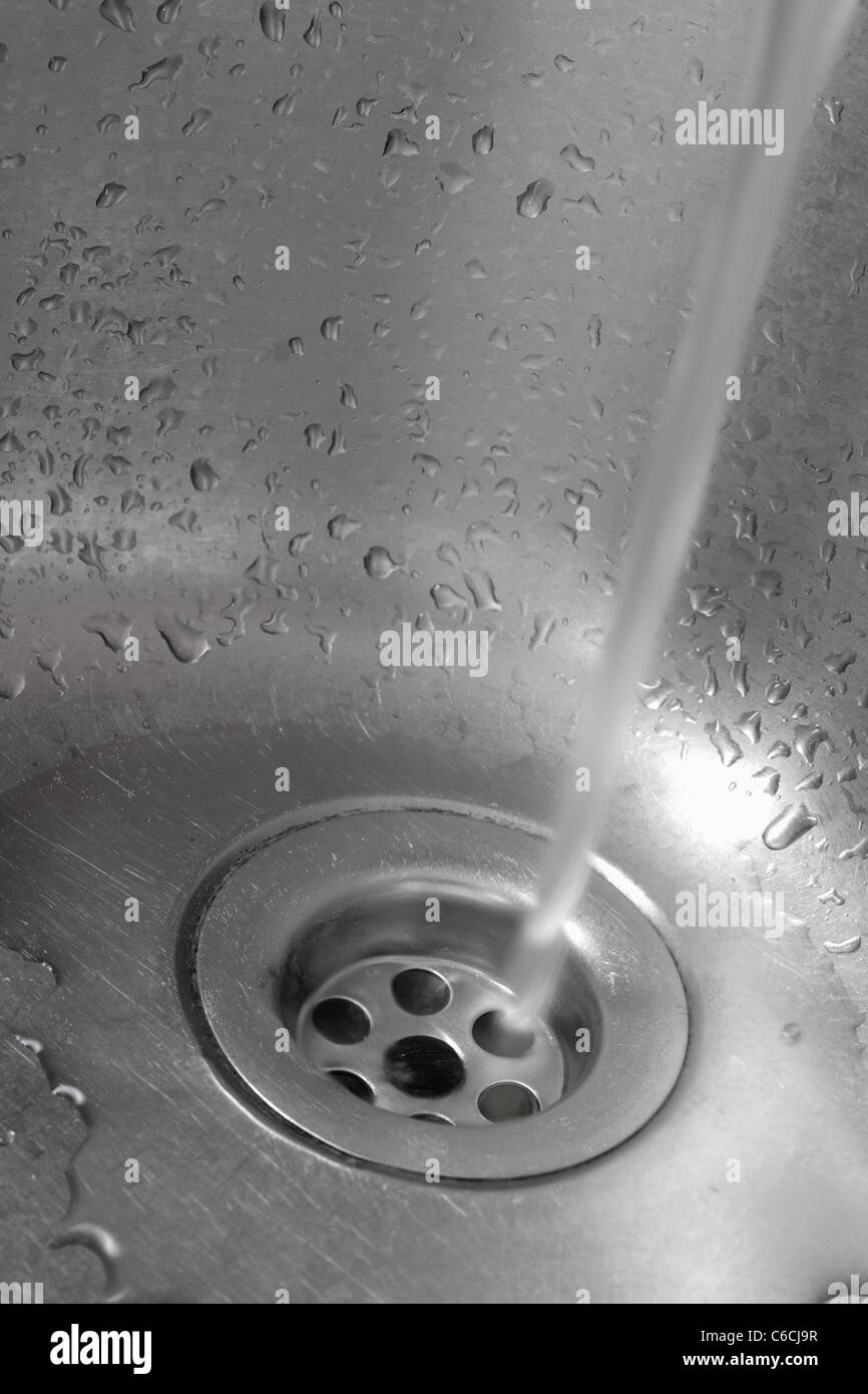 Metallic Kitchen sink with pouring water Stock Photo Alamy