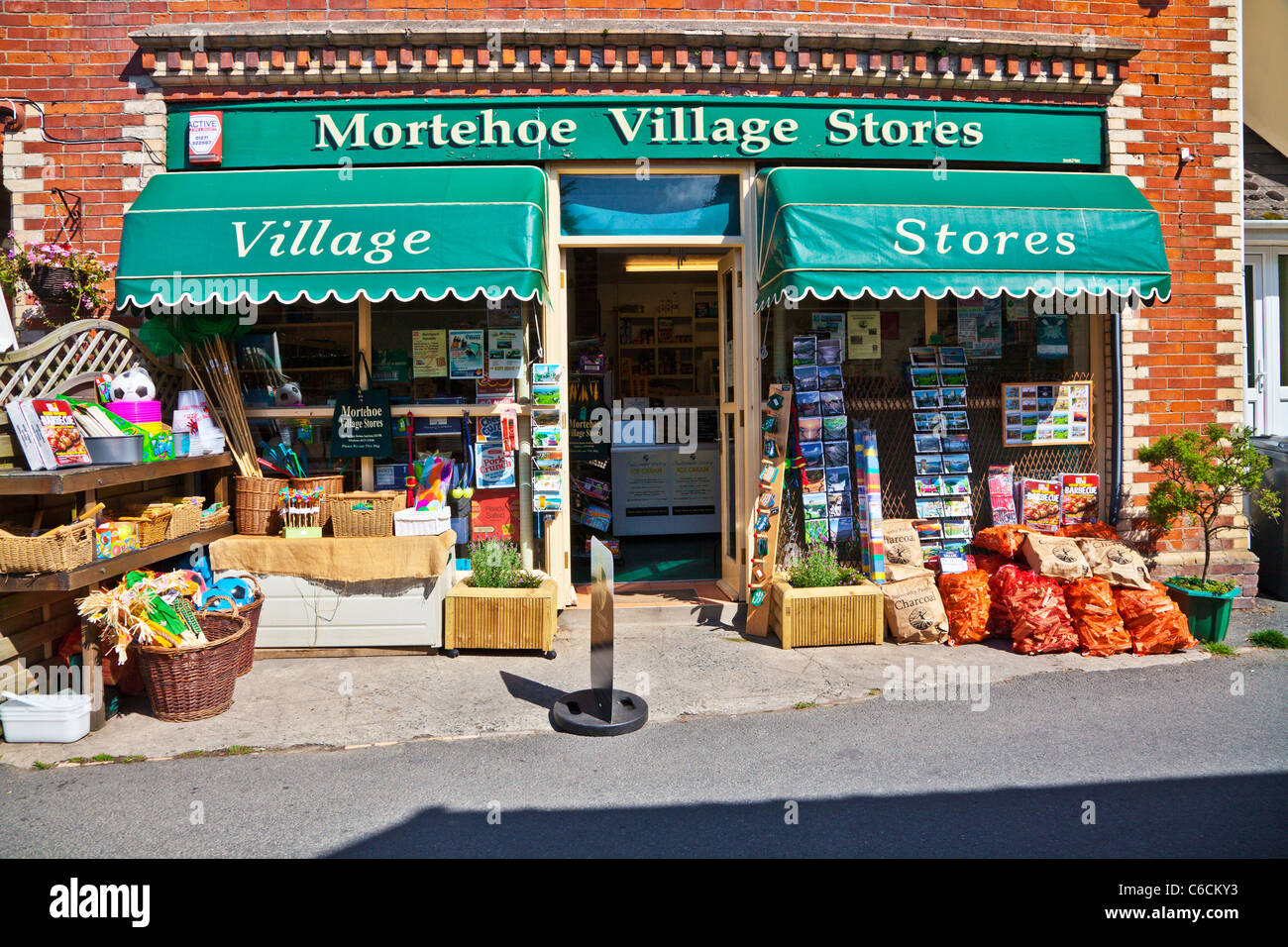 Typical English village grocer's shop or store in the pretty holiday resort of Morthoe near Woolacombe north Devon England UK Stock Photo