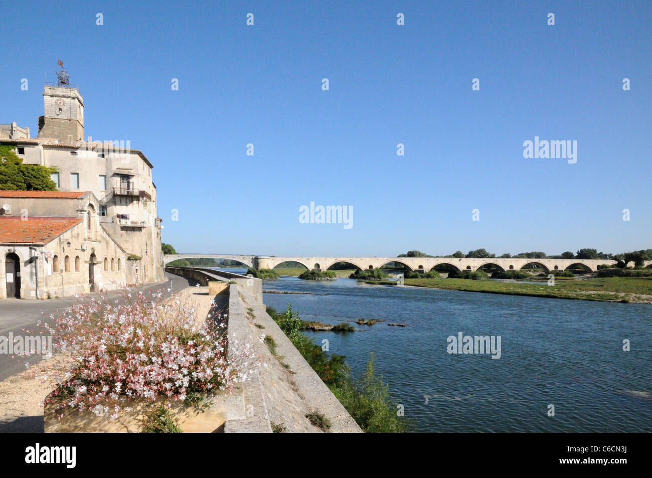 Old buildings and bridge over the river Rhone at Pont St Saint Esprit Gard France Stock Photo
