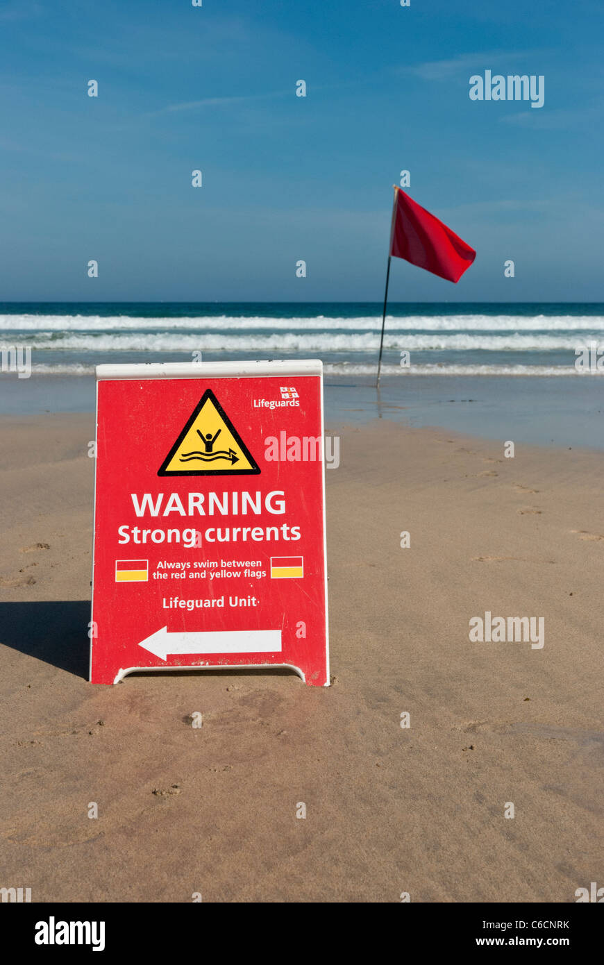 Sign warning of Strong Currents situated on Porthmeor Beach, St Ives, Cornwall, UK Stock Photo