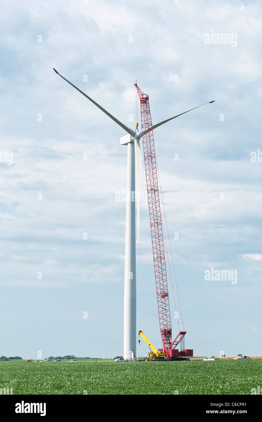 Construction workers assemble the rotor for a horizontal-axis wind turbine on a tower near Lakefield, Minnesota. Stock Photo