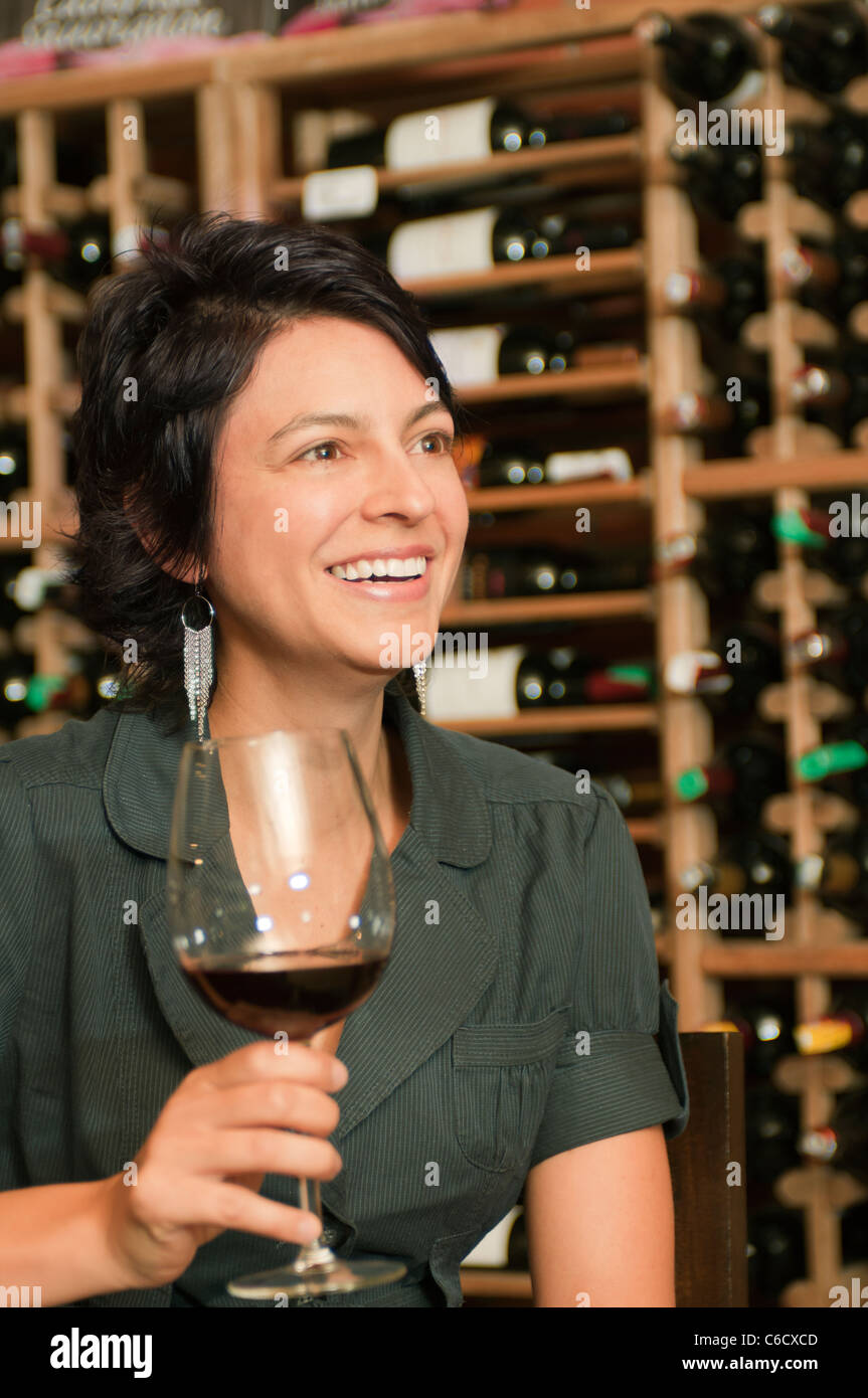 Hispanic woman drinking red wine Stock Photo - Alamy