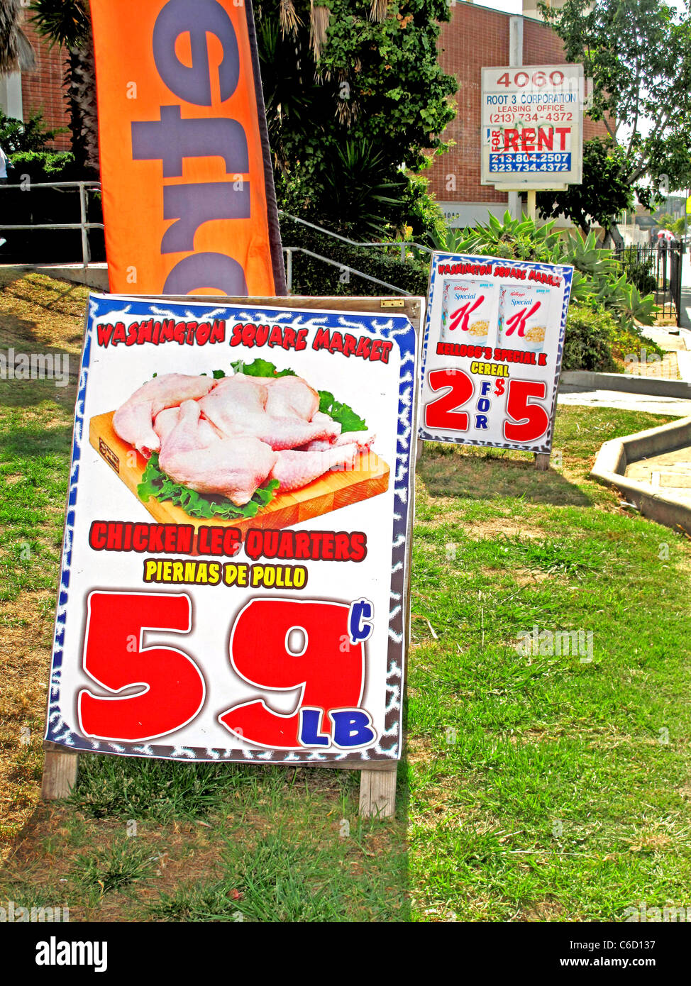 Spanish/English bilingual grocery signs advertise bargains in the ethnically mixed West Adams district of Los Angeles. Stock Photo