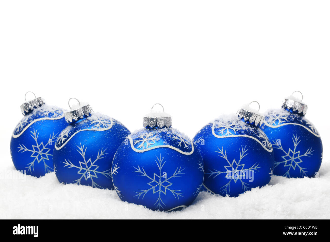 Christmas balls on snow over white background. Stock Photo