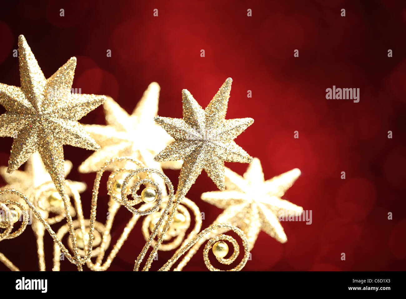Closeup of golden star on red background.Shallow Dof. Stock Photo