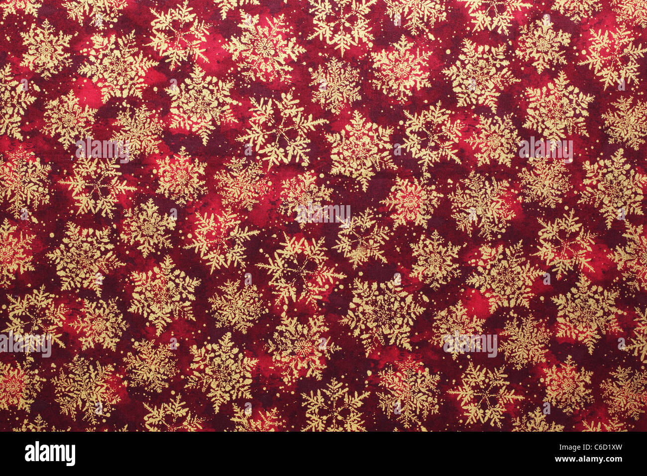 Golden snowflake pattern fabric background. Stock Photo