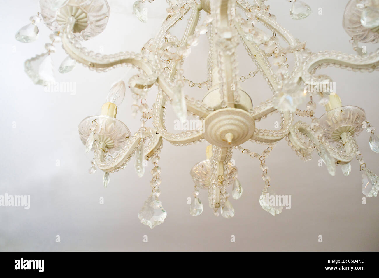 White chandelier against a white ceiling. Stock Photo