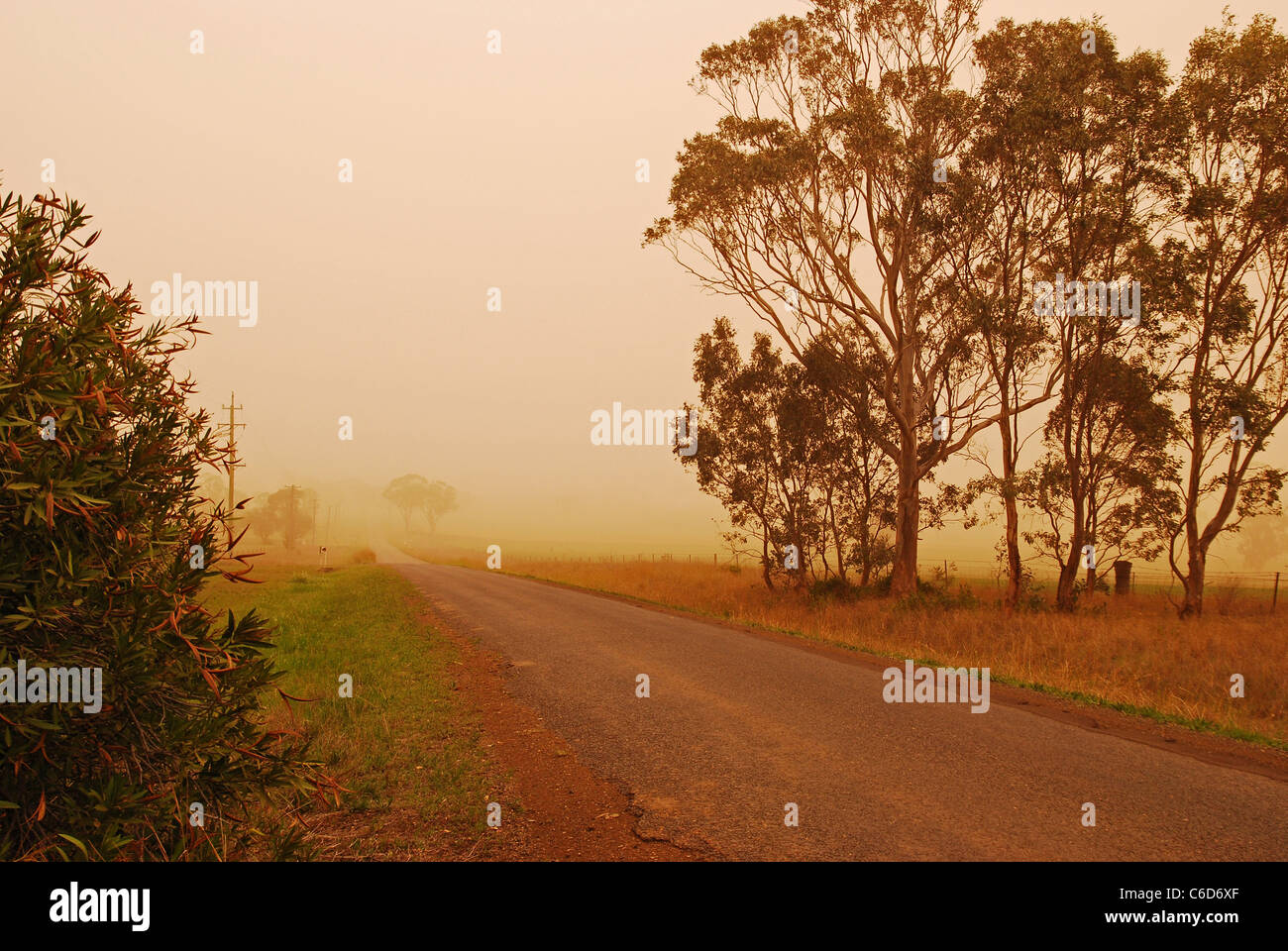 Dust clouds over a country road in Australia Stock Photo