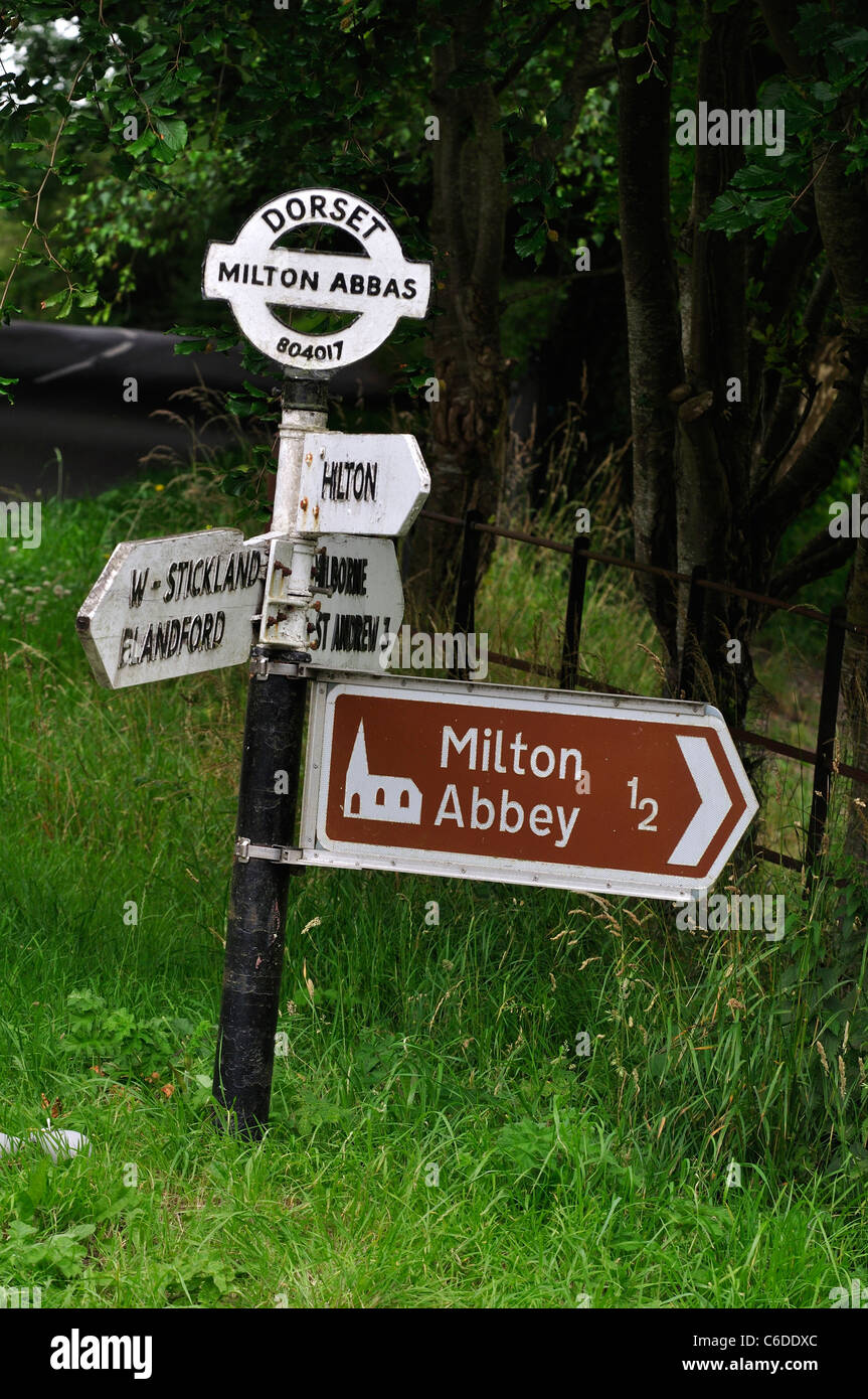 A traditional Dorset finger post near Milton Abbey with a 'brown sign' attached. UK Stock Photo