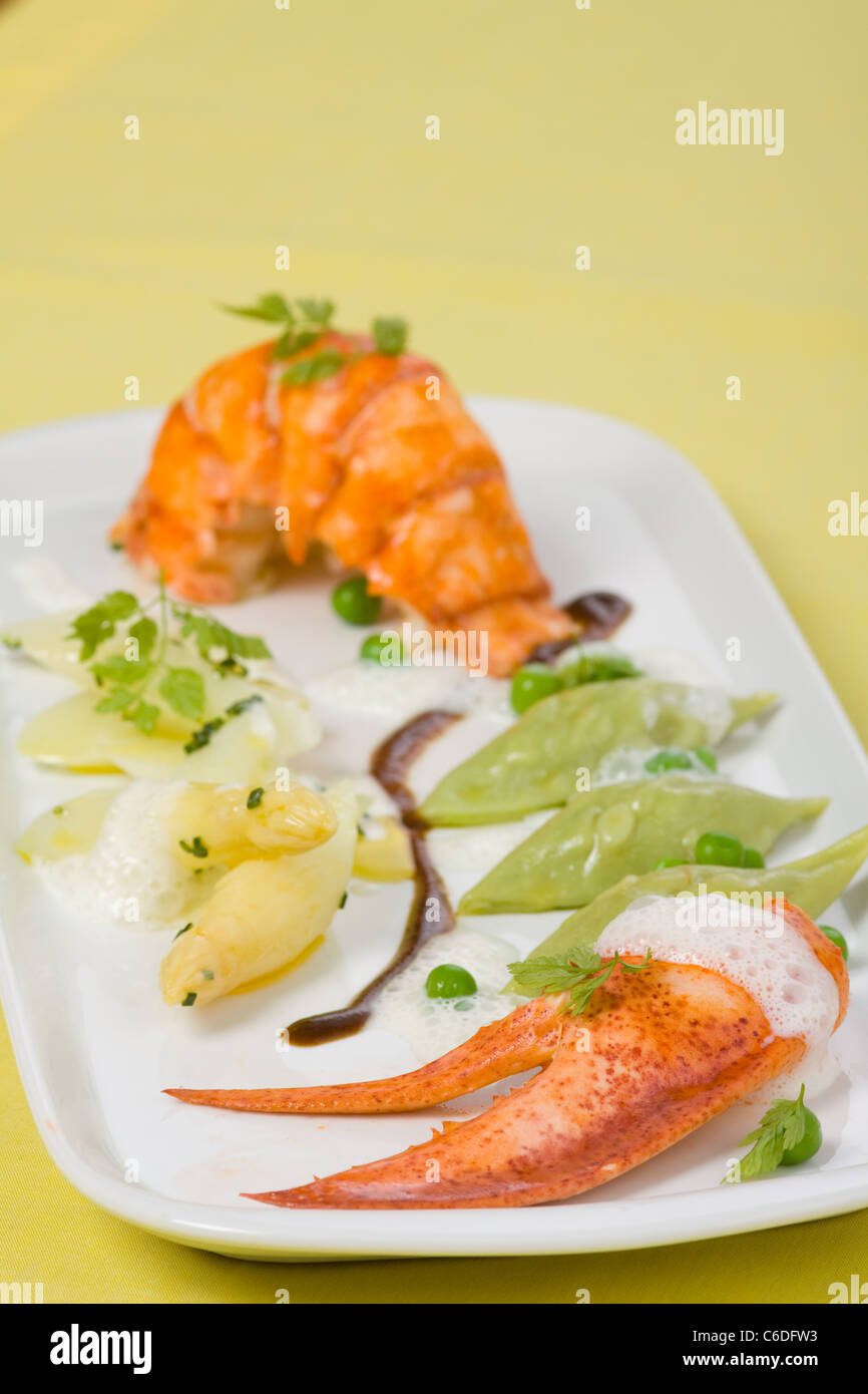 Canadian lobster with a variation of mushy peas and asparagus and chive salad Stock Photo