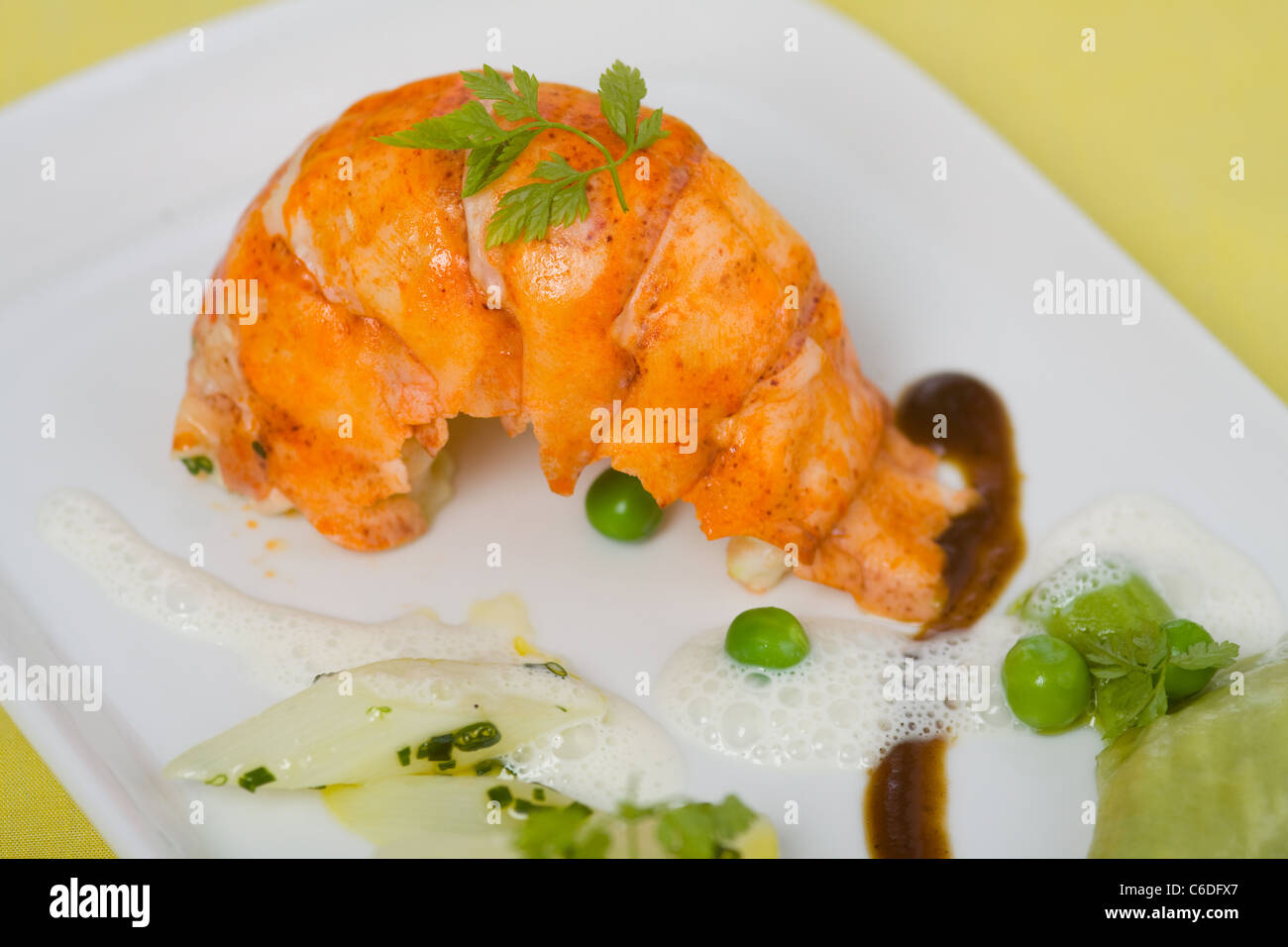 Canadian lobster with a variation of mushy peas and asparagus and chive salad Stock Photo