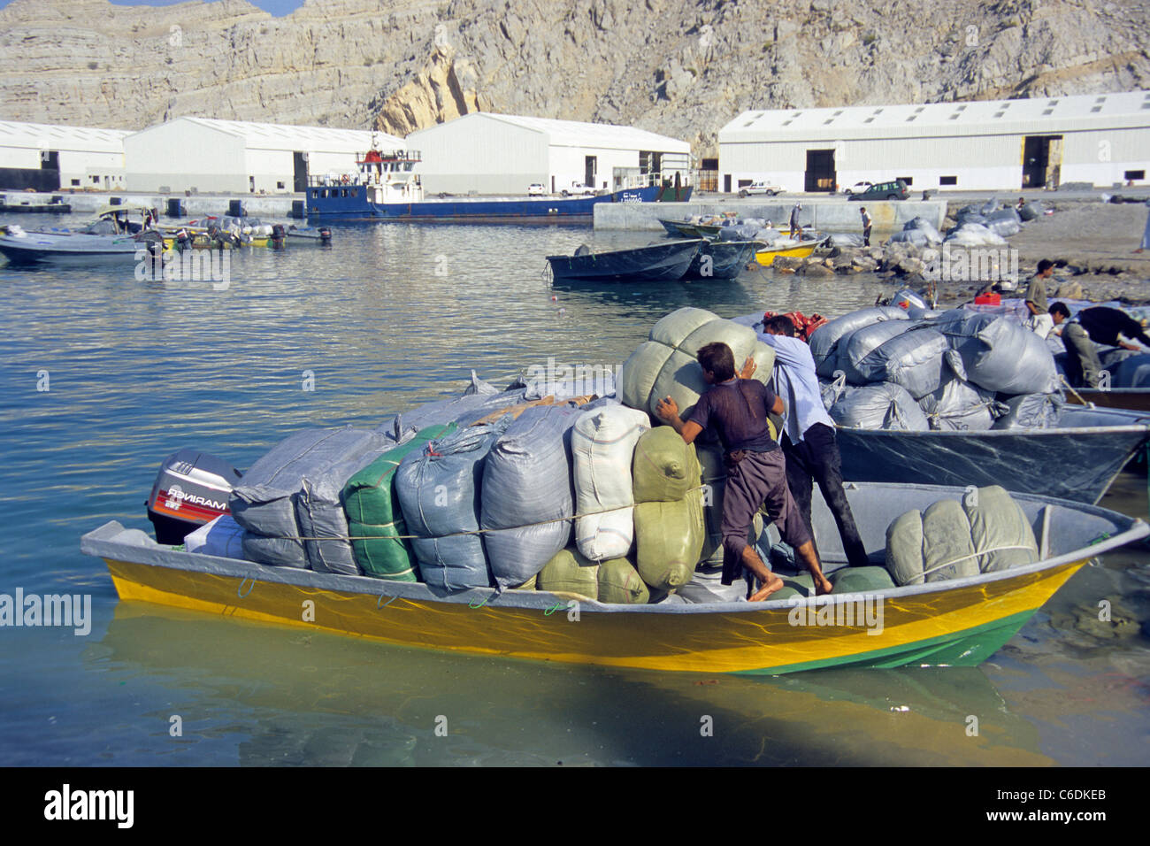 Smuggler from Iran loading goods to small but fast motor boats, smuggeling goods into the Iran, Khasab, Musandam, Oman Stock Photo