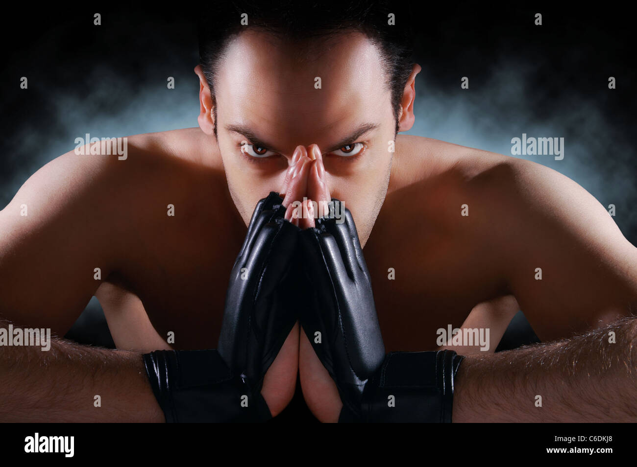 Mma fighter concentrating , staring at the camera , dramatic lighting Stock Photo