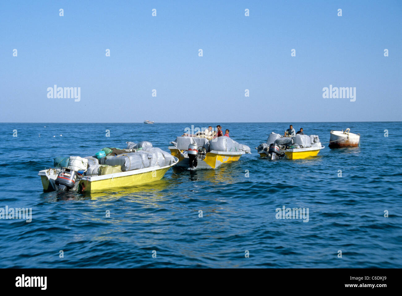 Smuggler on the way back from Oman to Iran, overloaded motor boats, smuggeling goods into Iran, Khasab, Musandam, Oman Stock Photo