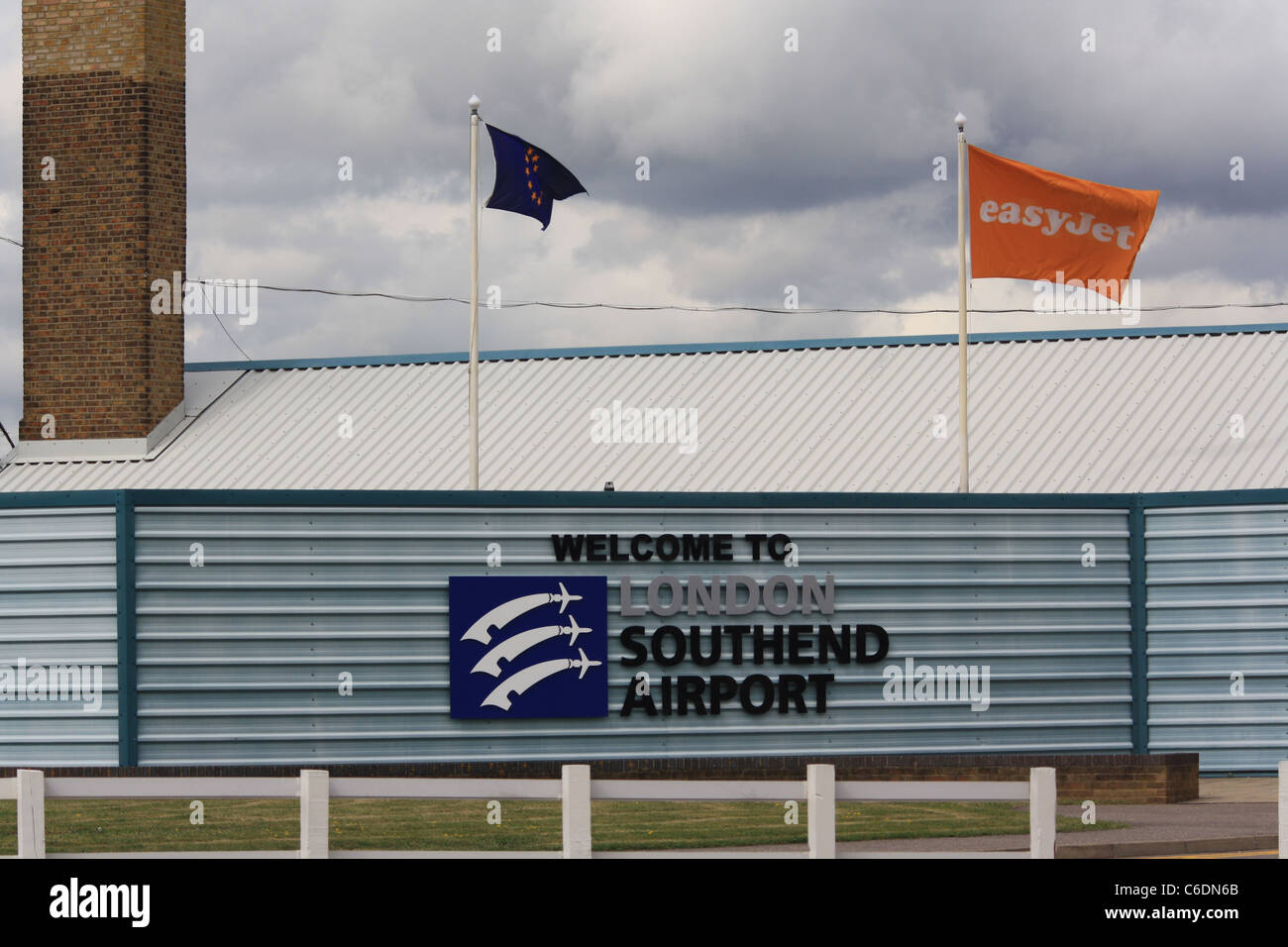 Easyjet flag flying over the southend airport sign. Stock Photo