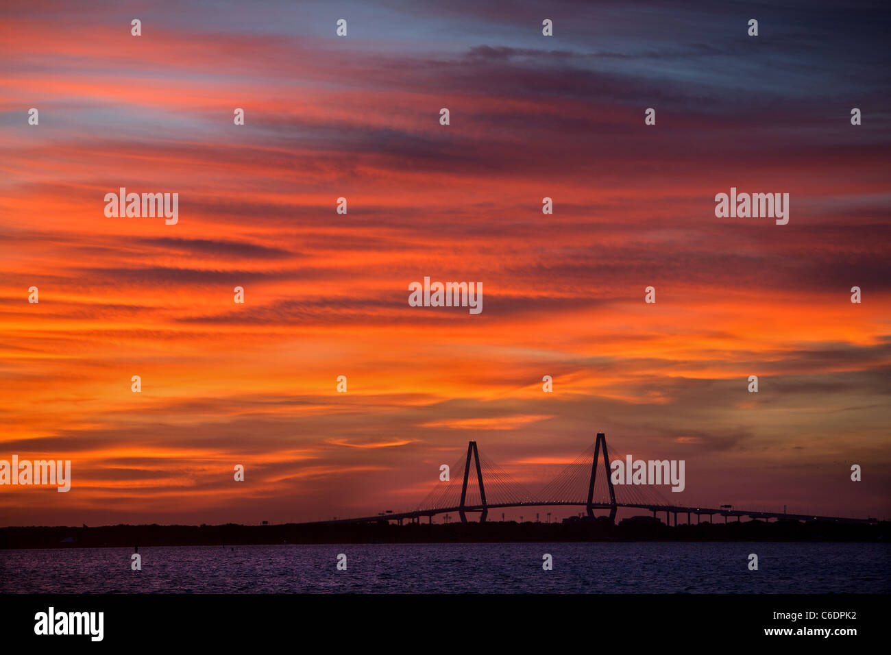 Sunset over Charleston, South Carolina harbor with Ravenel Bridge in background. Stock Photo