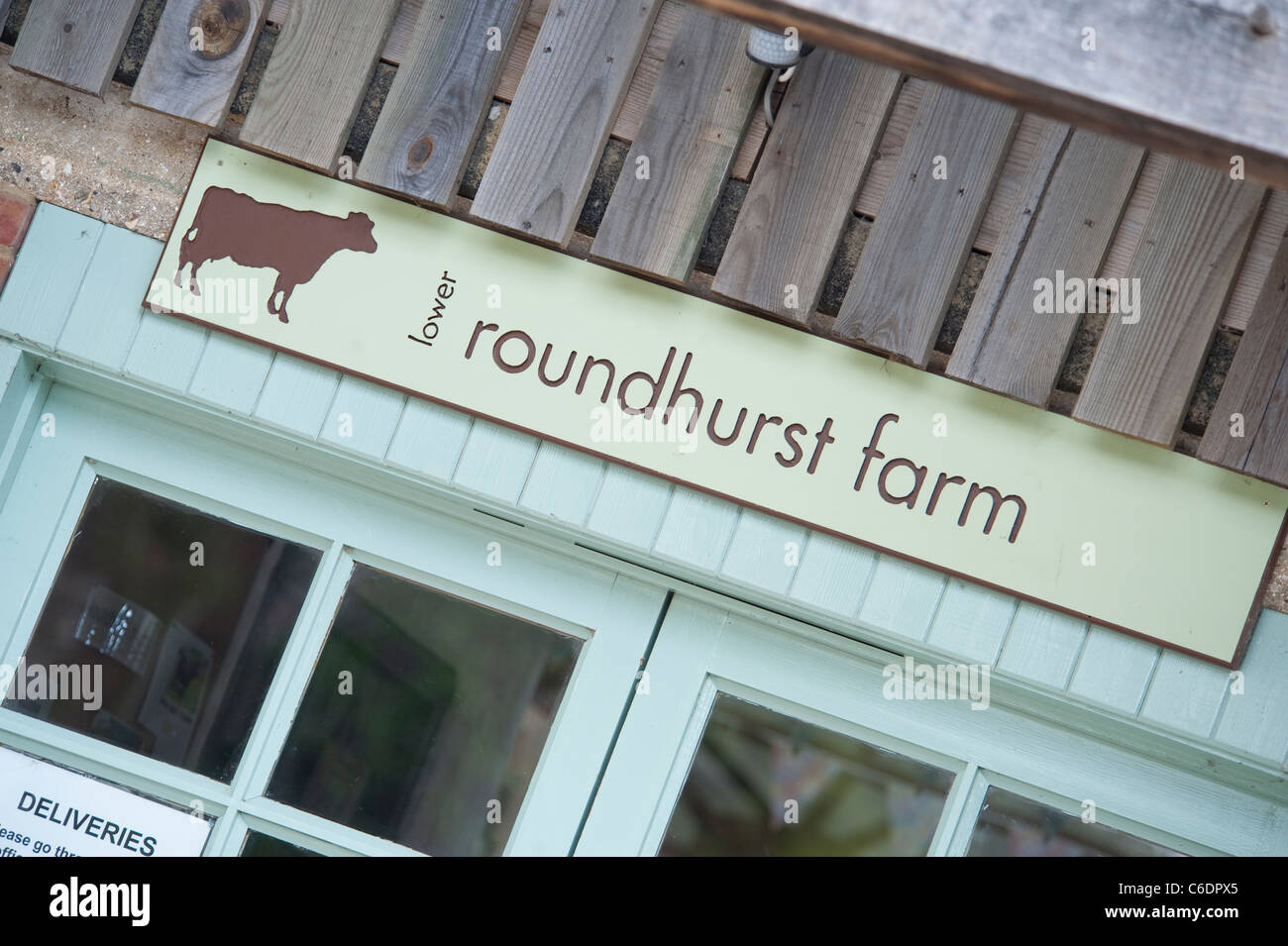 Sign above a farm shop called Roundhurst Farm, an organic farm in Farham Stock Photo