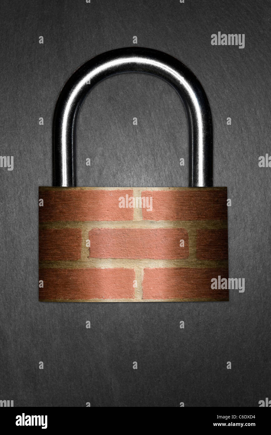 Home Security concept. Padlock with a brick wall superimposed on the body, signifying Home Security. Dark slate background Stock Photo