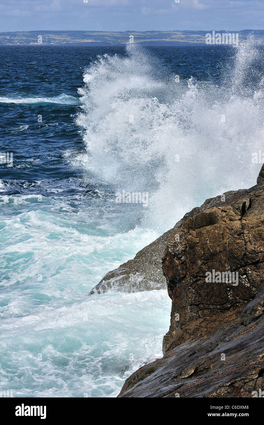 Waves crashing into rocks of cliff along the Brittany coast, France Stock Photo