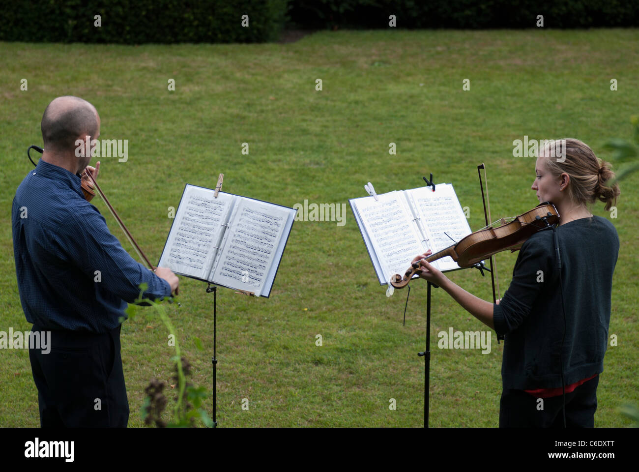 Two violinist entertain visitors to Renishaw Hall, Derbyshire, England, UK. Stock Photo