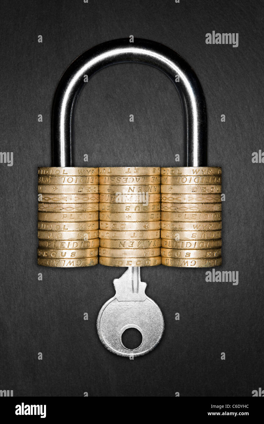 Financial Security concept. Padlock made form pound coins. Key inserted into padlock Stock Photo