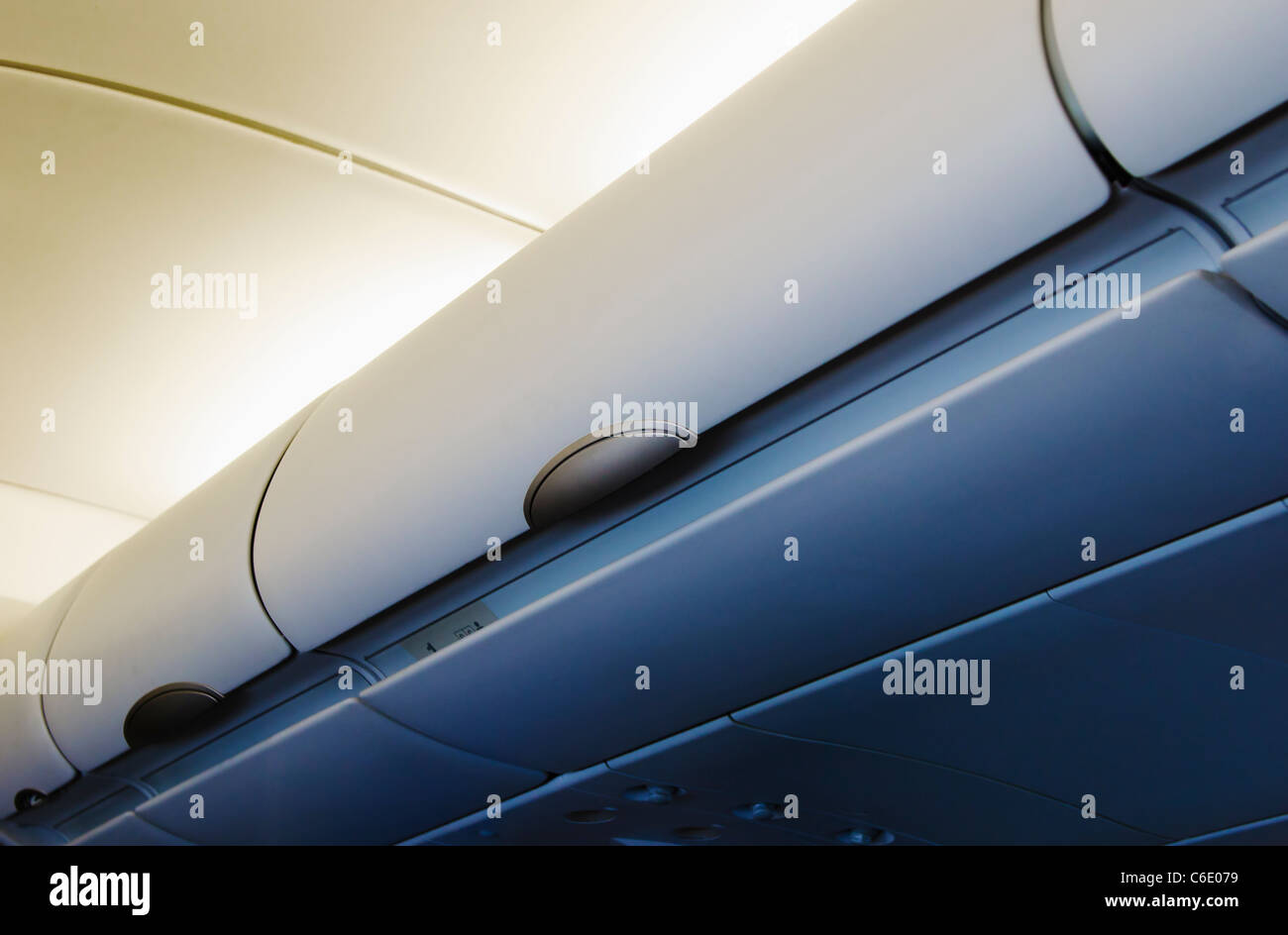 Overhead storage compartment in airplane Stock Photo Alamy