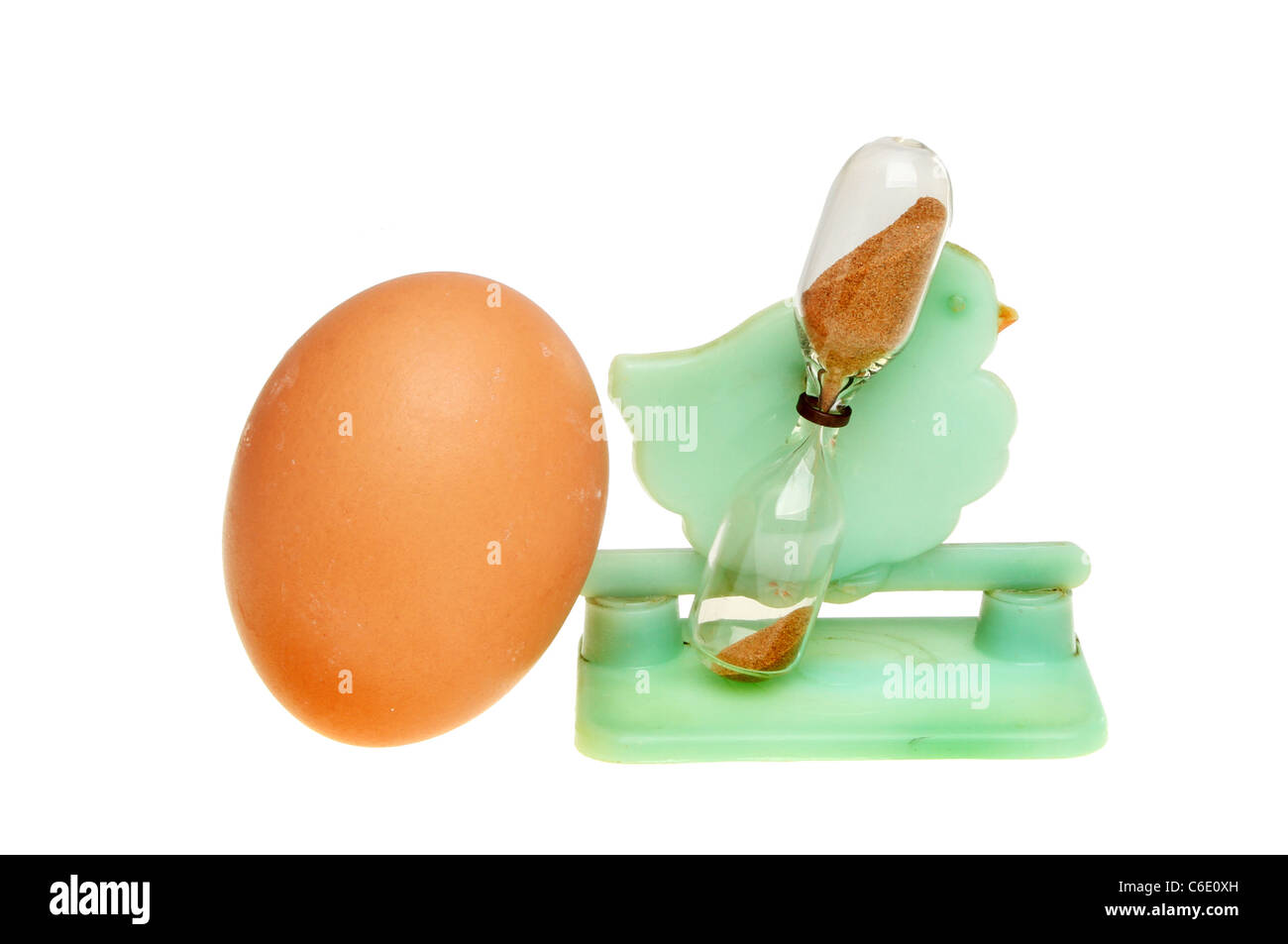 Egg and retro chicken shaped egg timer isolated against white Stock Photo