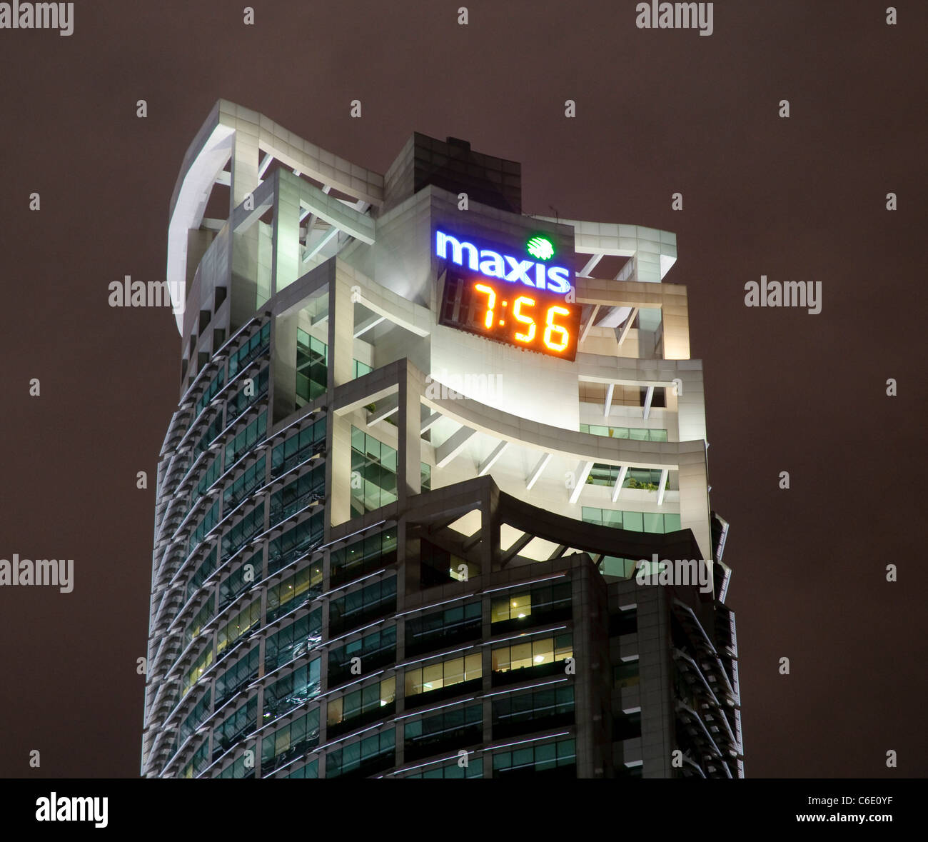 Office building with a digital clock illuminated at night, Kuala Lumpur, Malaysia, Southeast Asia, Asia Stock Photo