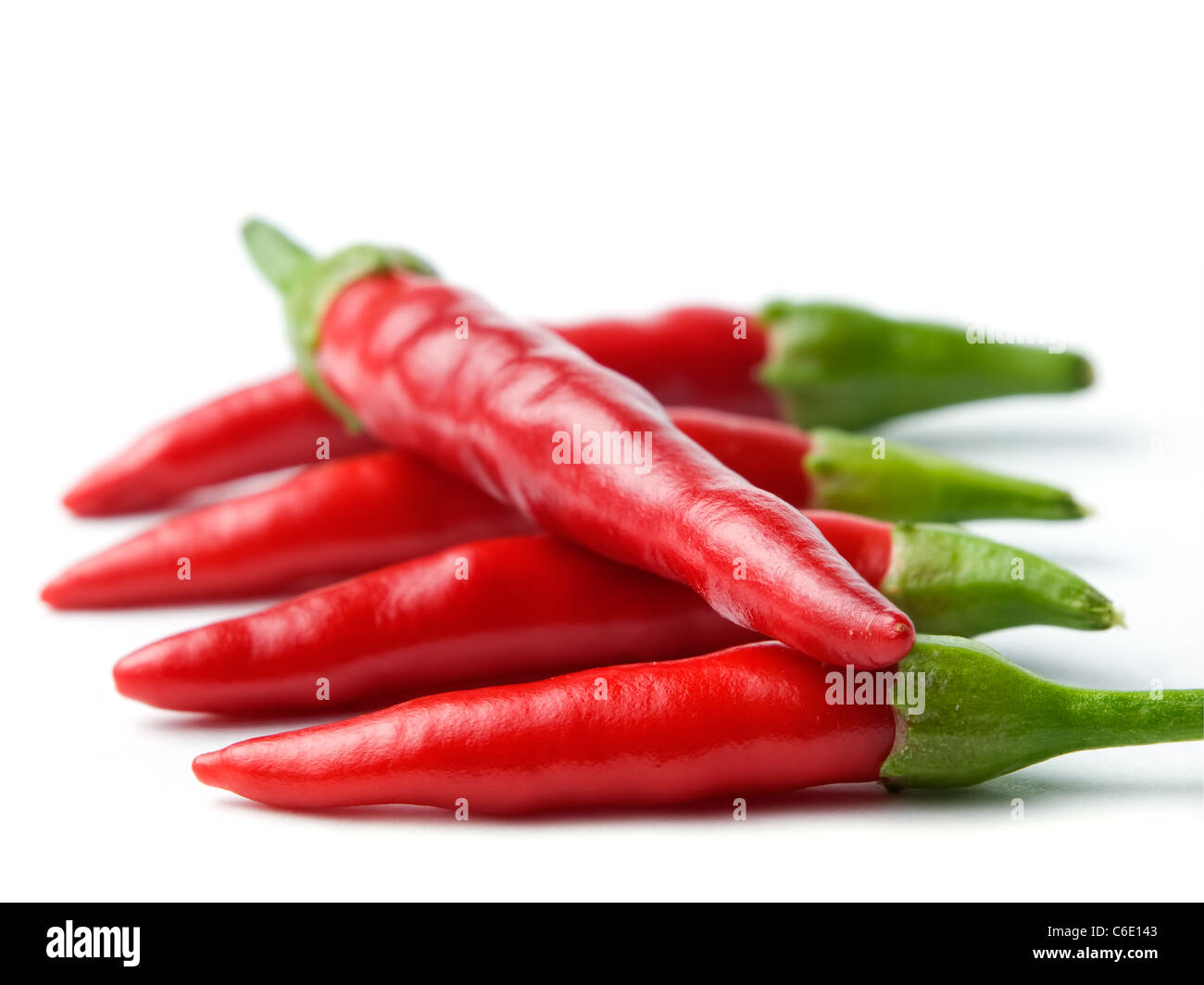 Five chili peppers sorted on a white background Stock Photo - Alamy
