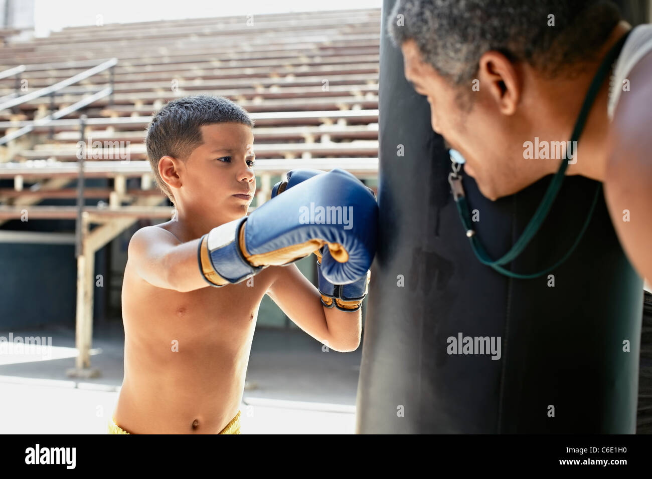 Hispanic boy boxing punching bag Stock Photo Alamy