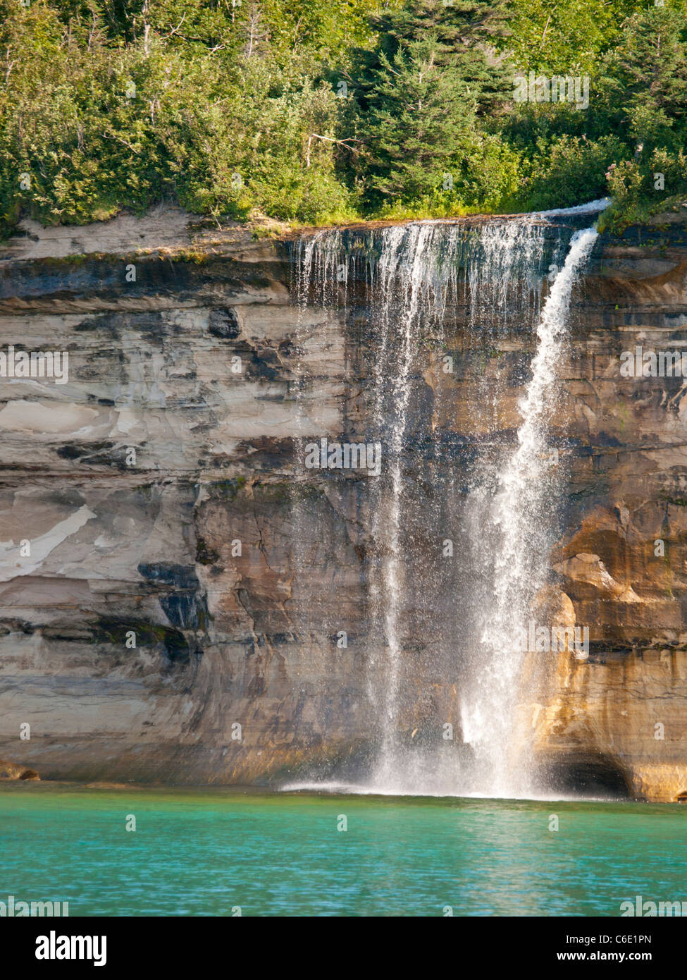 Spray Falls plunges about 70 feet over the Pictured Rocks cliffs directly into Lake Superior. Stock Photo
