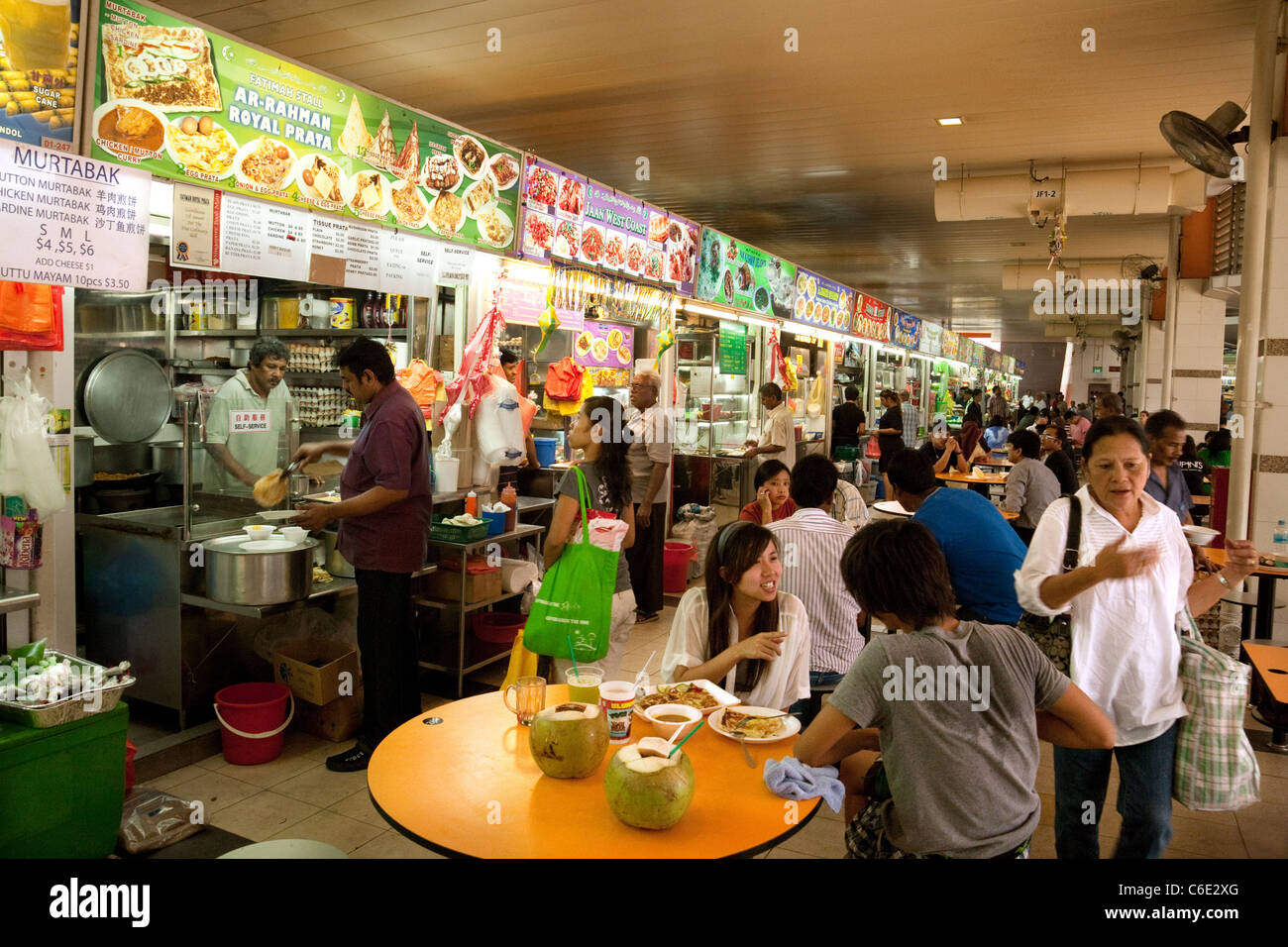 People eating food in the Hawker centre in the indoor Tekka market