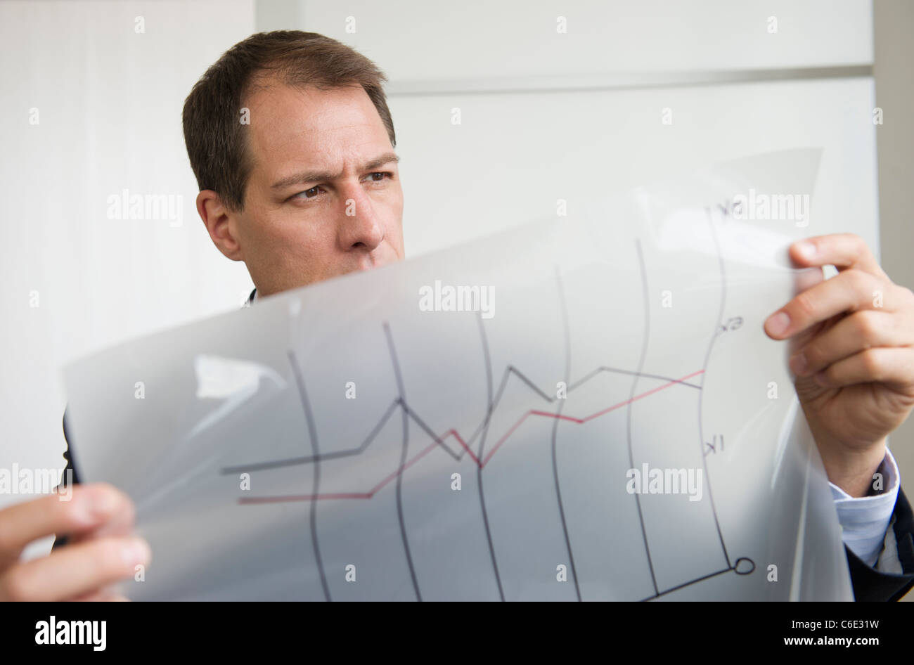 USA, New Jersey, Jersey City, Businessman analyzing graphs Stock Photo