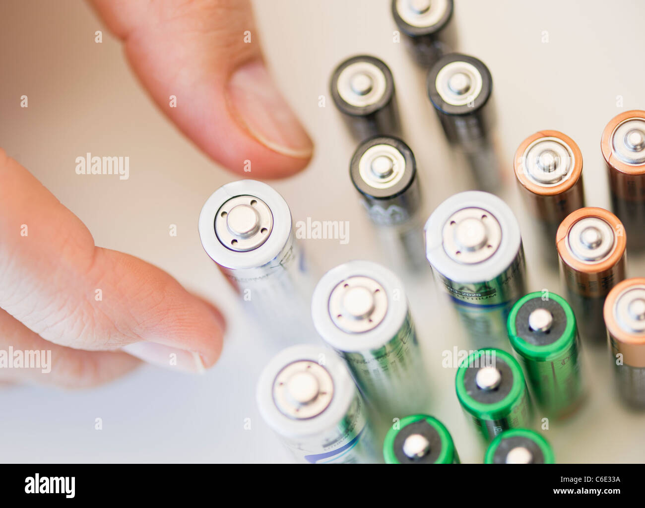 Hand holding batteries Stock Photo