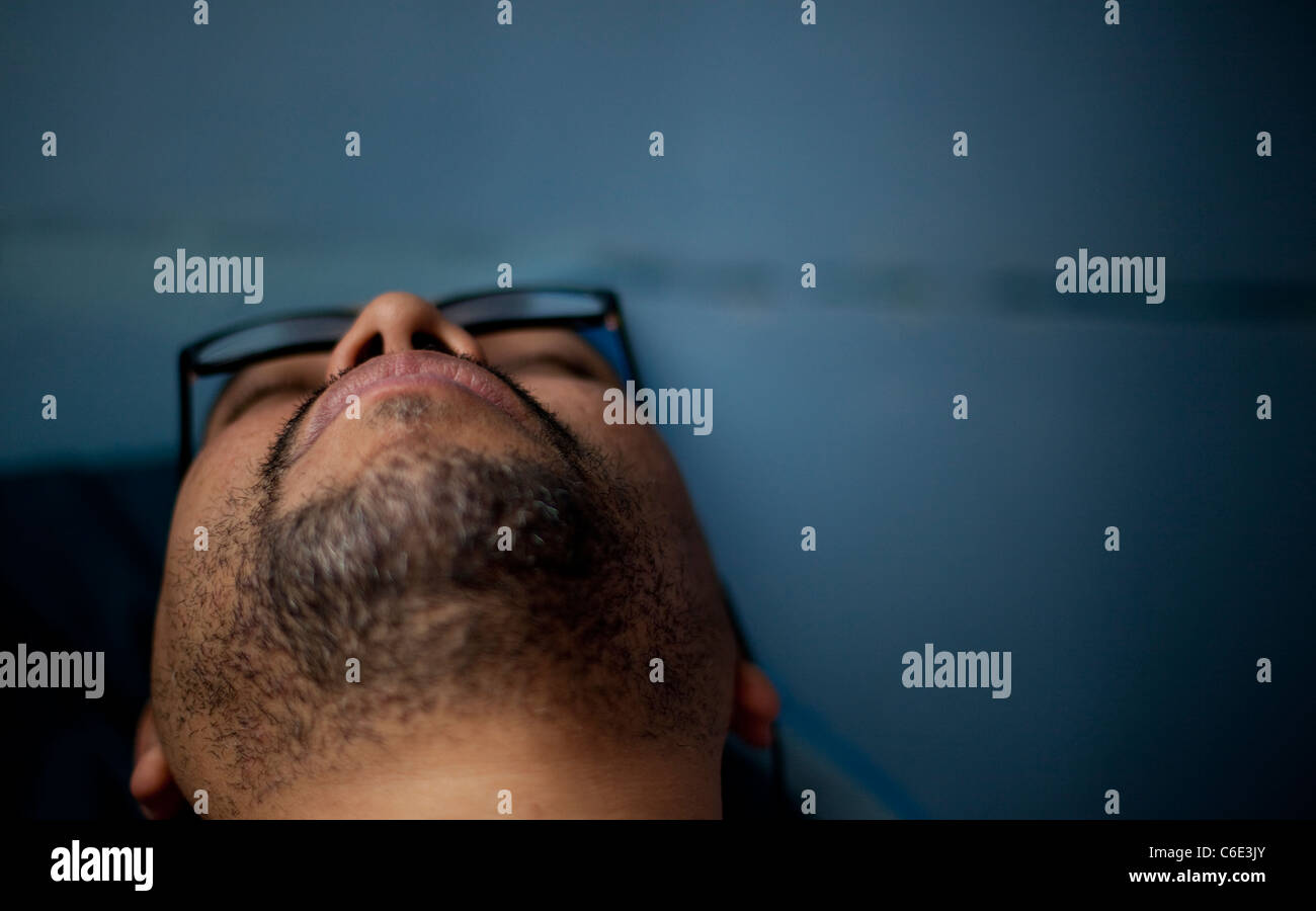 Man sleeping with glasses on Stock Photo